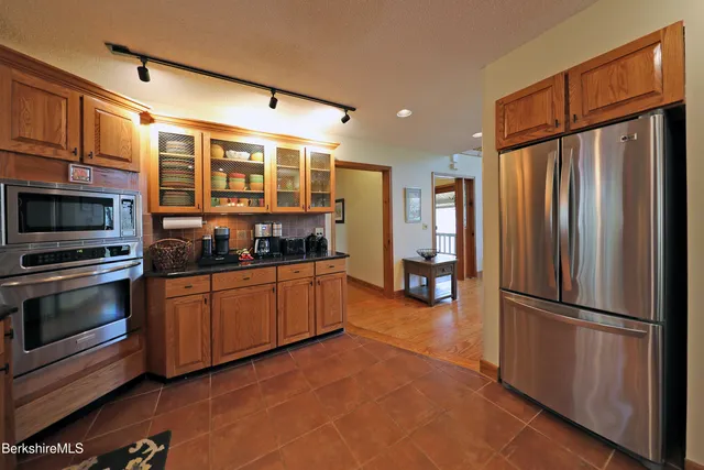 a kitchen with stainless steel appliances granite countertop a refrigerator oven a sink and dishwasher