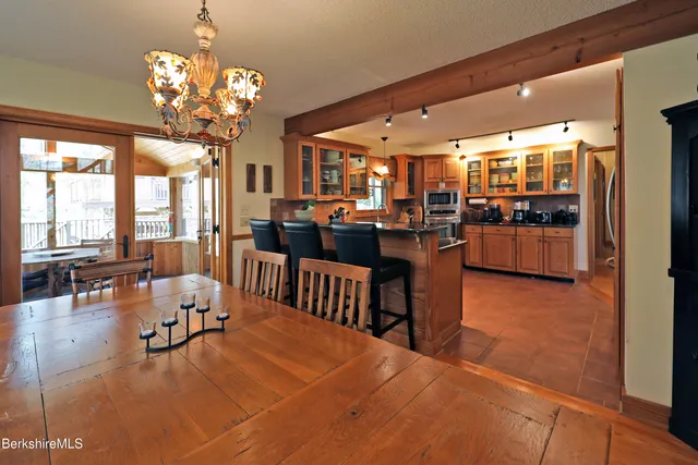 a living room with lots of furniture and chandelier