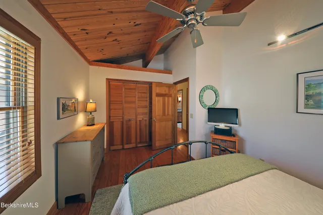 a bedroom with furniture and a wooden floor
