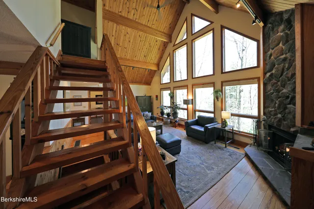 a view of staircase with wooden floor and furniture
