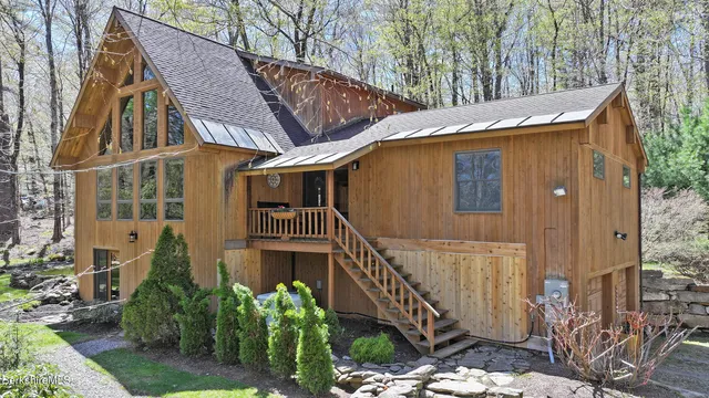 a view of a house with wooden fence