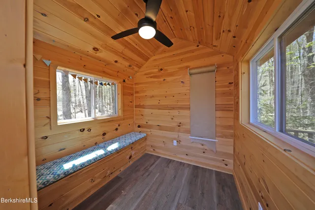 a room with wooden floors and windows