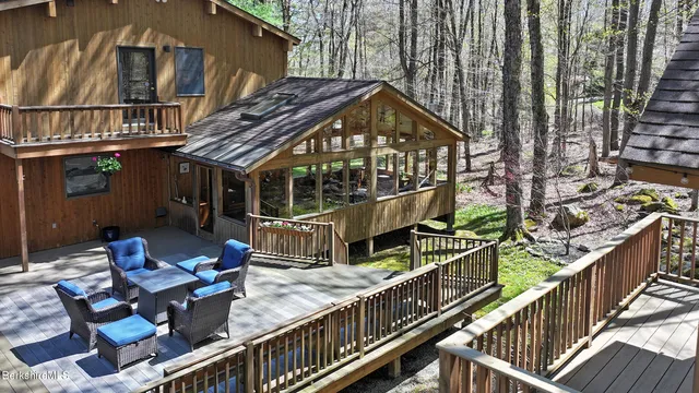 a view of house with roof deck and furniture