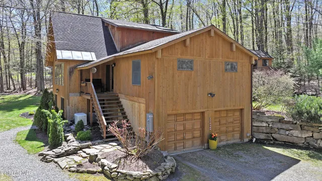 a view of a house with brick walls