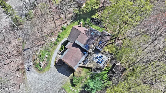 an aerial view of a house with a yard