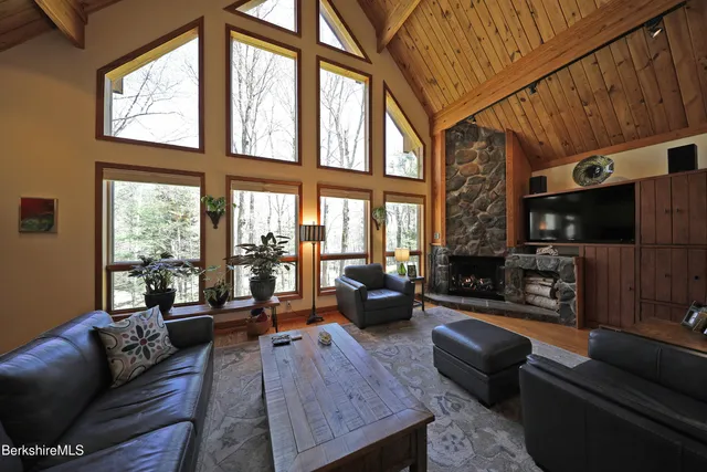 a living room with furniture a fireplace and a flat screen tv