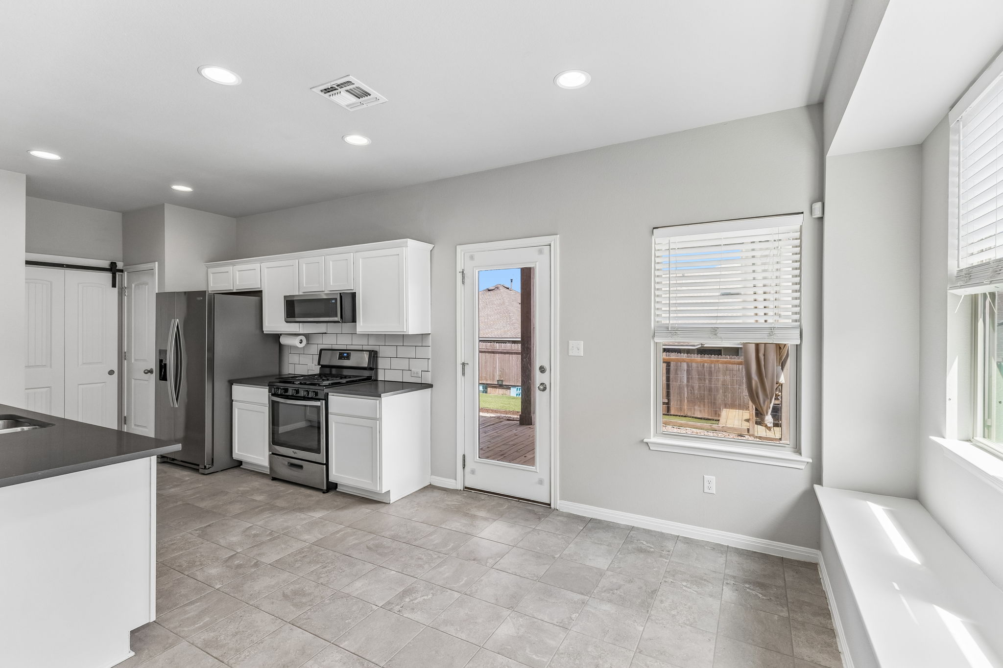 689 Nautical Loop Kyle, TX 78640 - Photo 13 of 34 A well-equipped kitchen offers ample counter space and convenient access to the outdoor deck.