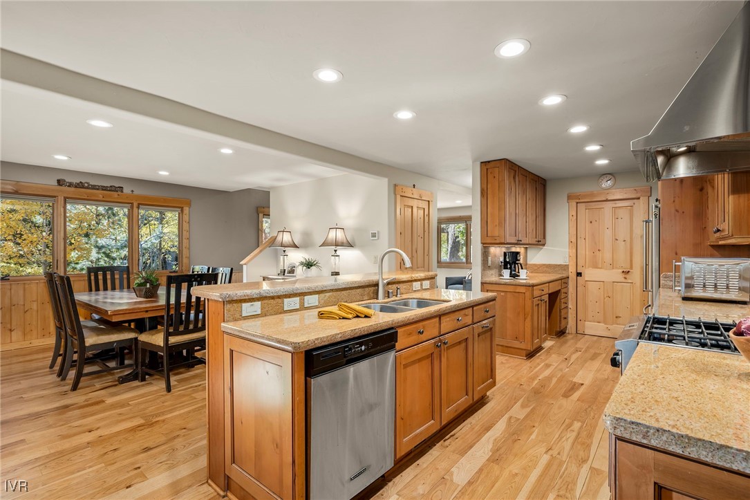 1089 Oxen Road Incline Village, NV 89451 - Photo 11 of 33 a kitchen with stainless steel appliances granite countertop a stove top oven a sink dishwasher a dining table and chairs with wooden floor