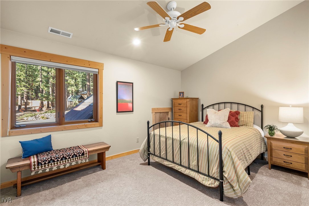 1089 Oxen Road Incline Village, NV 89451 - Photo 22 of 33 a bedroom with a bed and a chandelier