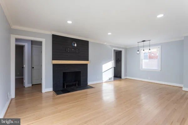 an empty room with windows and a fireplace