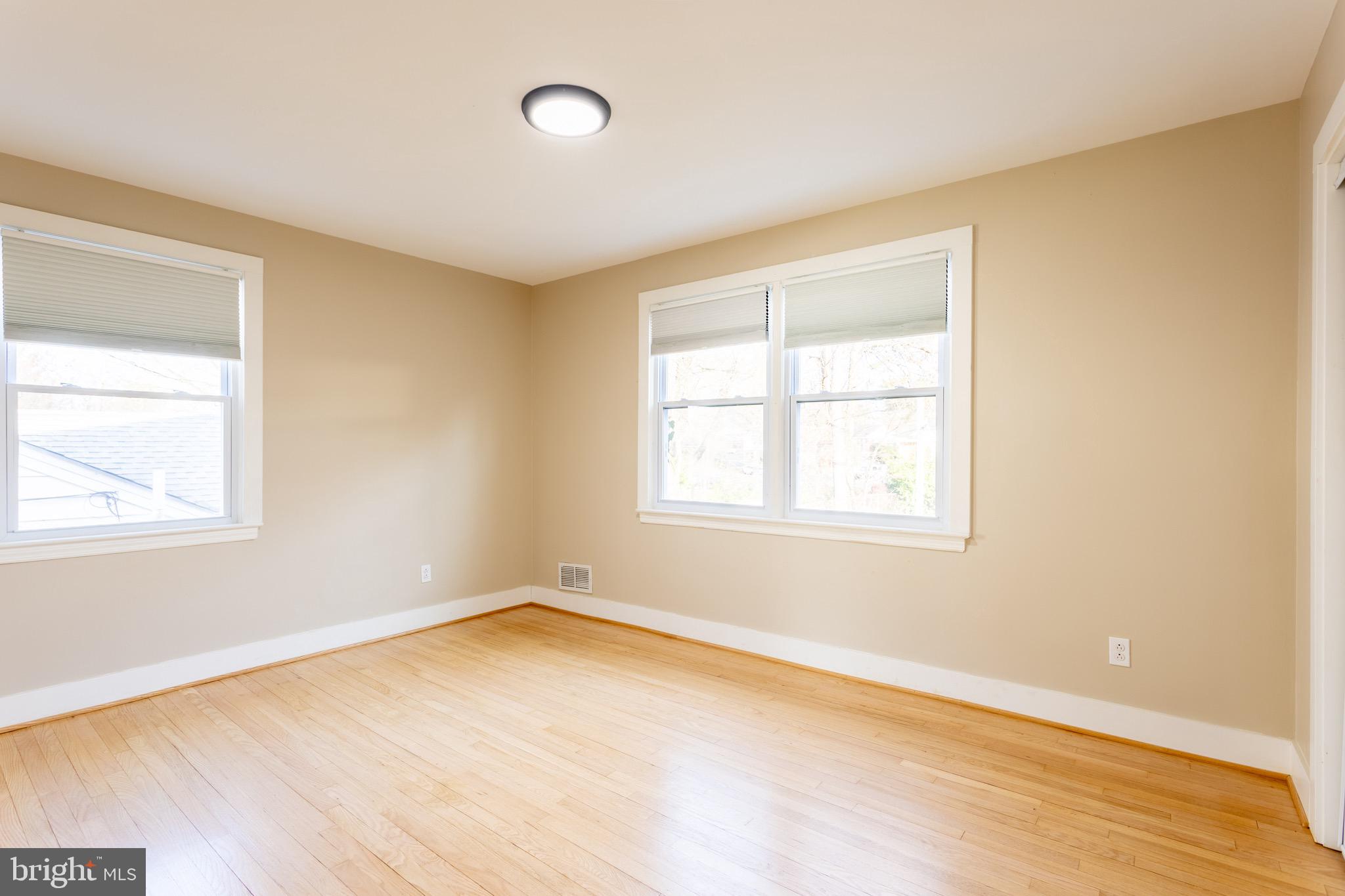 1809 Florin Street Silver Spring, MD 20902 - Photo 15 of 41 an empty room with wooden floor and windows