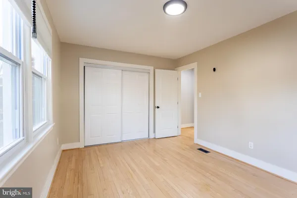 a living room with furniture and a painting on the wall