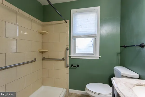 a white toilet sitting next to a bathroom sink