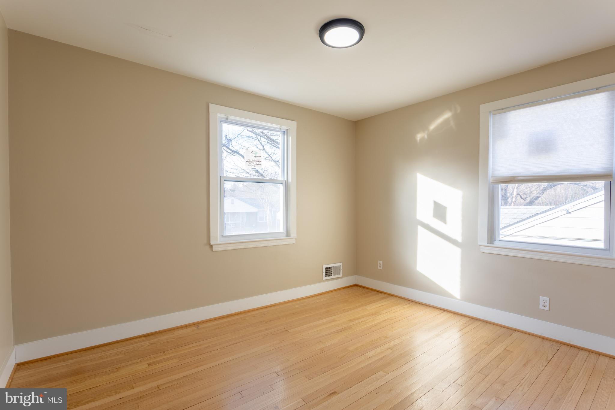 1809 Florin Street Silver Spring, MD 20902 - Photo 22 of 41 an empty room with wooden floor and windows