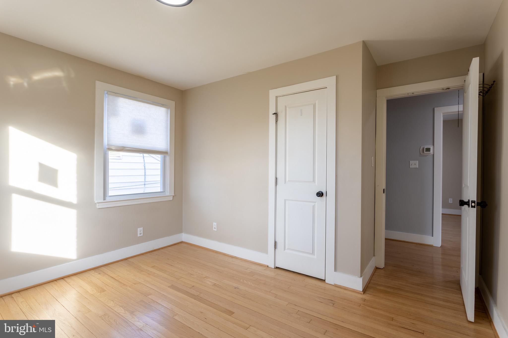 1809 Florin Street Silver Spring, MD 20902 - Photo 23 of 41 a view of an empty room with wooden floor and a window