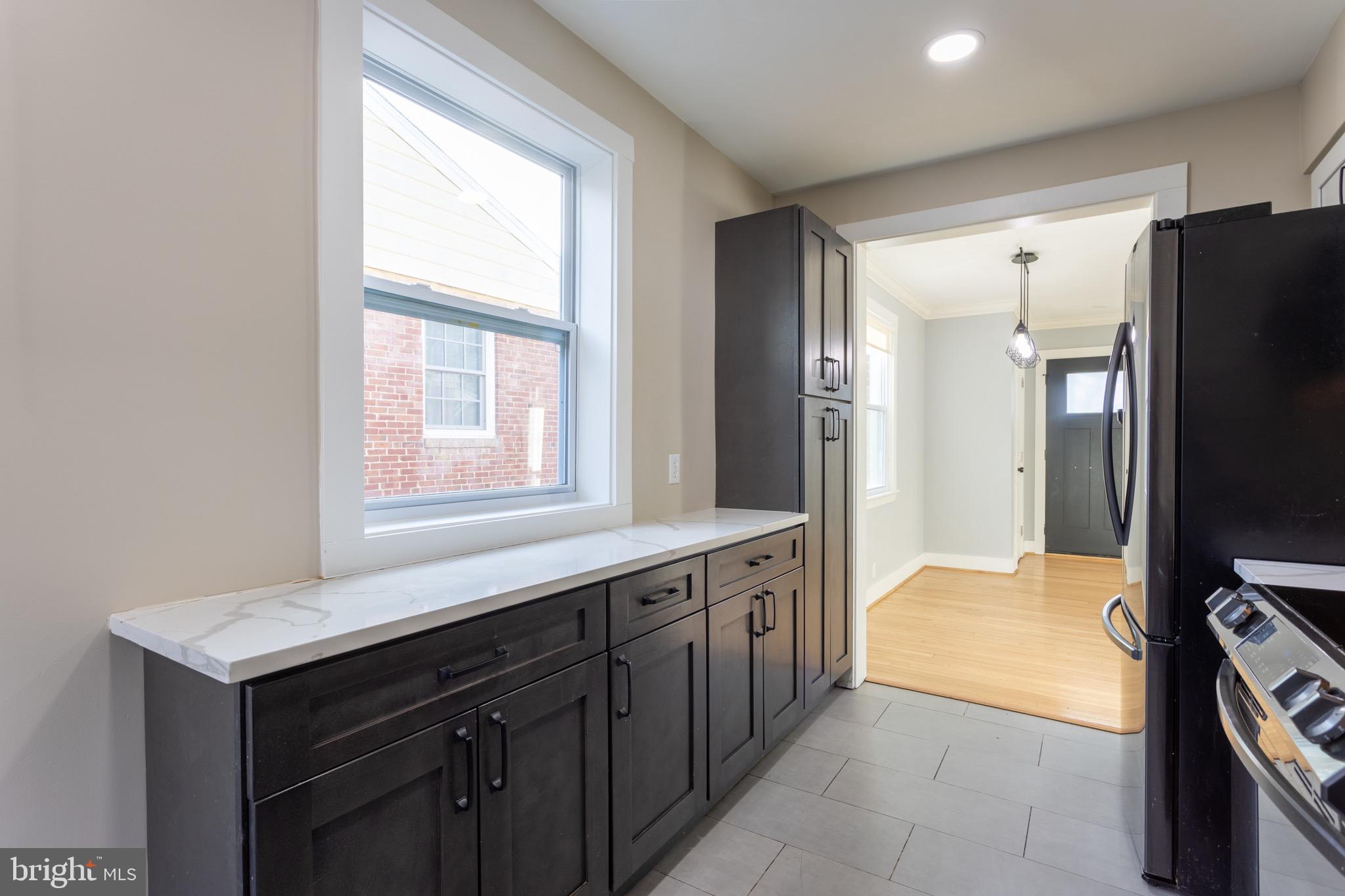 1809 Florin Street Silver Spring, MD 20902 - Photo 25 of 41 a kitchen with stainless steel appliances granite countertop a refrigerator and a sink