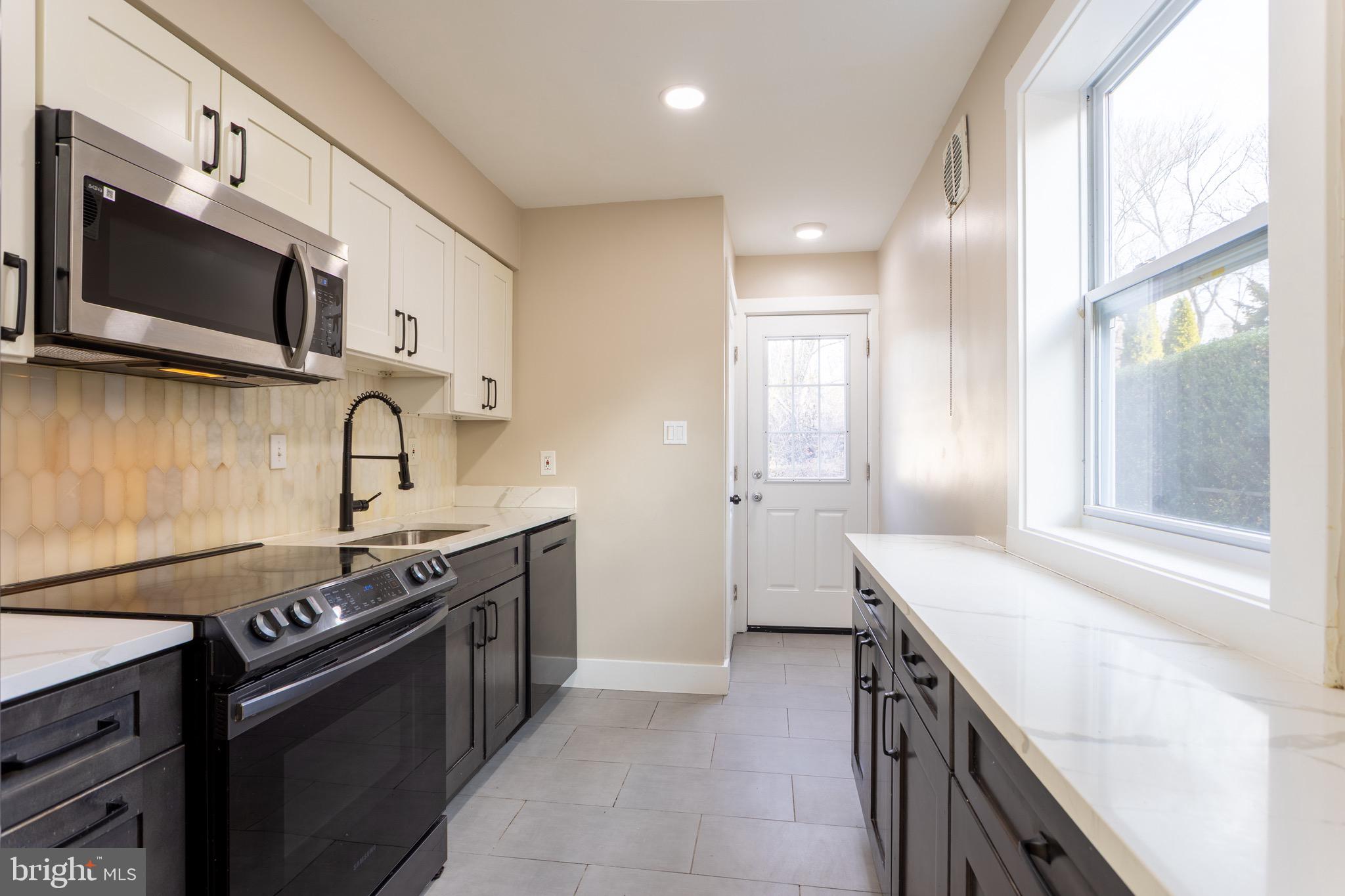 1809 Florin Street Silver Spring, MD 20902 - Photo 26 of 41 a kitchen with stainless steel appliances granite countertop a sink and a stove