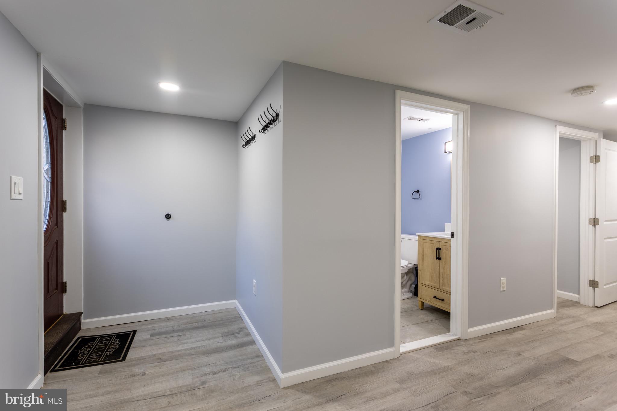 1809 Florin Street Silver Spring, MD 20902 - Photo 28 of 41 an empty room with wooden floor and bathroom view