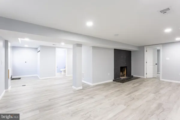 a view of an empty room with a fireplace