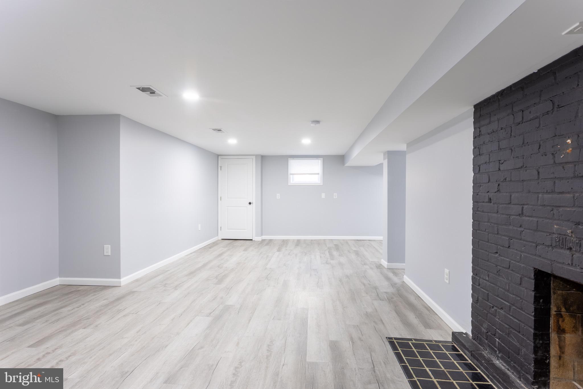 1809 Florin Street Silver Spring, MD 20902 - Photo 33 of 41 a view of an empty room with wooden floor and a fireplace