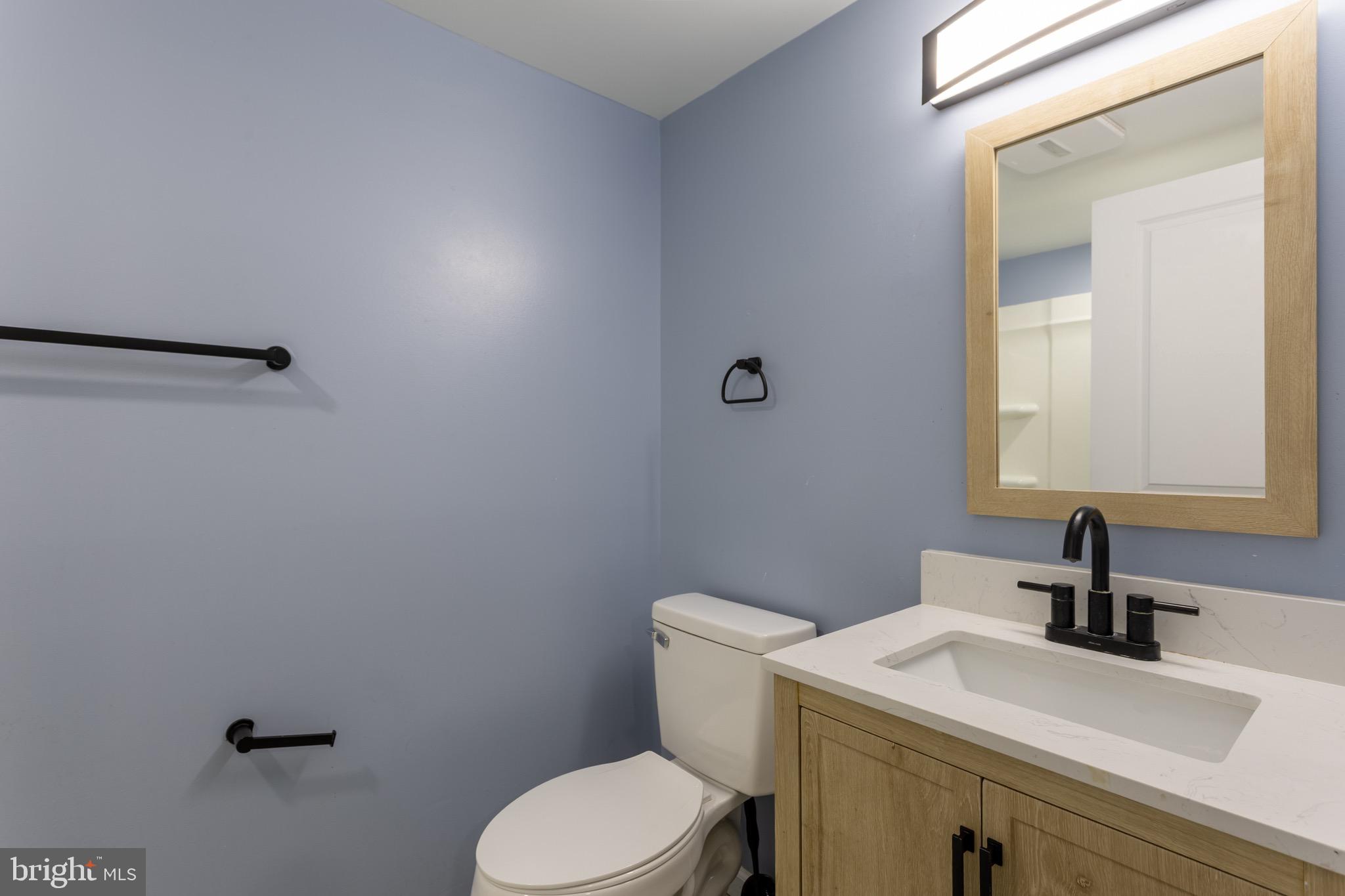 1809 Florin Street Silver Spring, MD 20902 - Photo 37 of 41 a bathroom with a sink a toilet and mirror