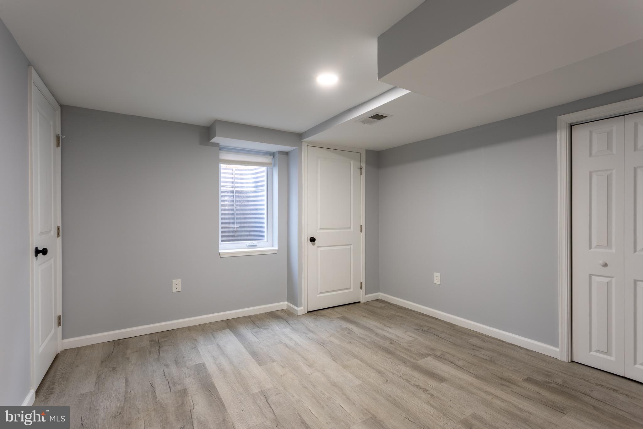 1809 Florin Street Silver Spring, MD 20902 - Photo 39 of 41 a view of an empty room with wooden floor and a window
