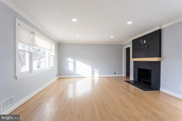 wooden floor in an empty room with a window