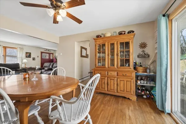 a dining room with furniture a chandelier and wooden floor