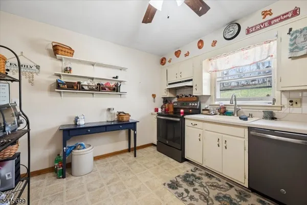 a kitchen with a sink cabinets and window