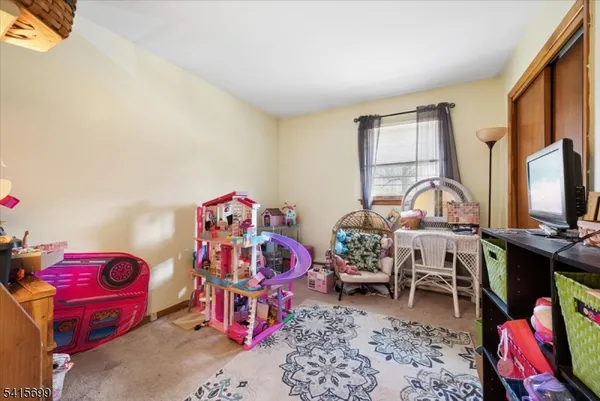 a bedroom with a bed closet and window