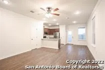a view of a kitchen with a sink and a refrigerator
