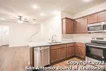 a kitchen with a sink a stove and cabinets