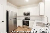 a kitchen with a refrigerator stove and microwave
