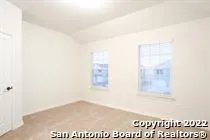 a bathroom with a granite countertop sink a mirror and shower