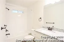 a bathroom with a sink a mirror and a shower