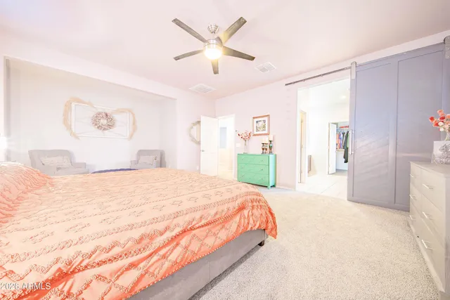 a spacious bedroom with a bed and a walk in closet