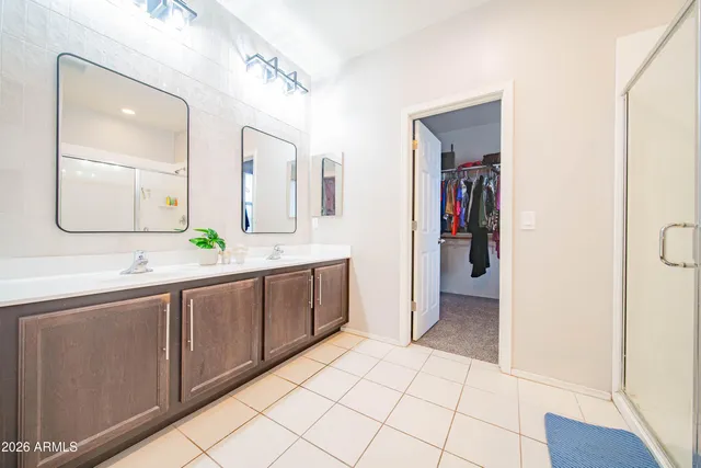 a spacious bathroom with a double vanity sink and a mirror