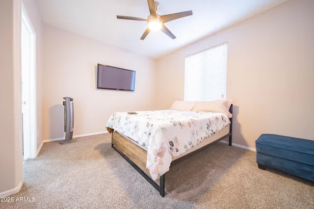 a bedroom with a bed and a dresser