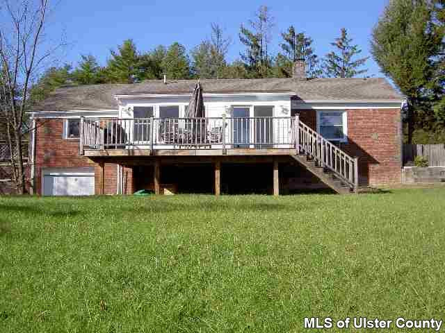 4167 Highway 209 Stone Ridge, NY 12484 - Photo 1 of 4 a front view of a house with a garden