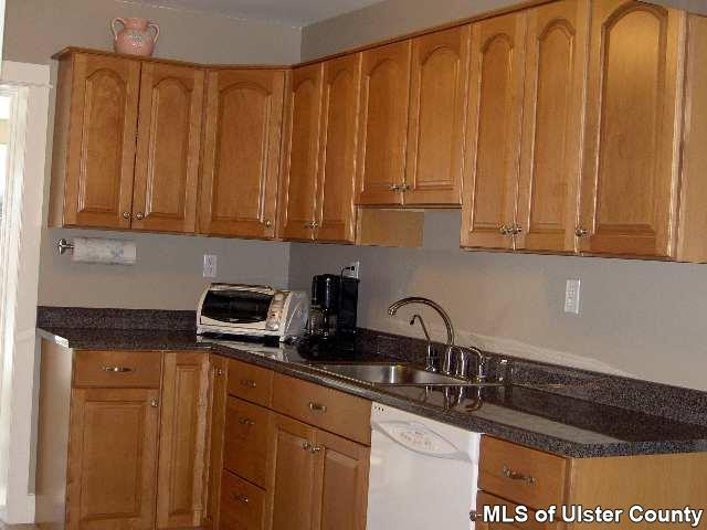 4167 Highway 209 Stone Ridge, NY 12484 - Photo 4 of 4 a kitchen with granite countertop a sink a stove and cabinets