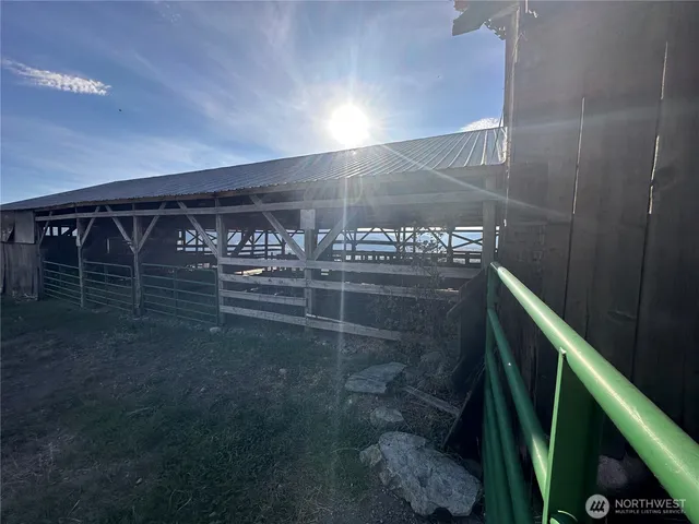 a view of a balcony with chair and wooden floor