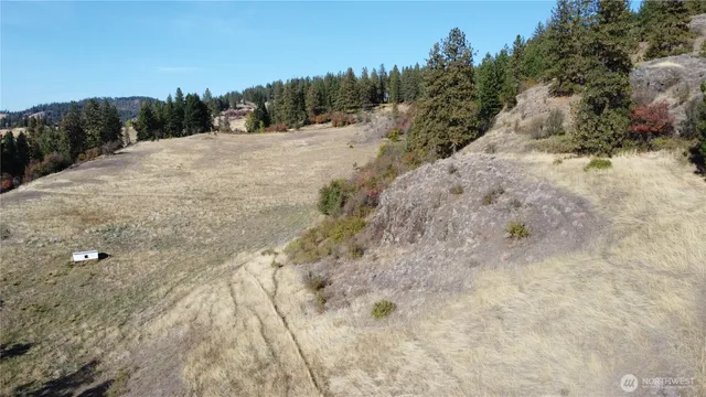 a view of a house with a yard and sitting area