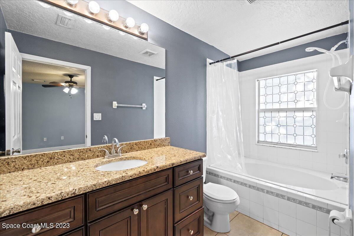 6949 Boston Road Cocoa, FL 32927 - Photo 15 of 33 a bathroom with a granite countertop sink toilet and shower
