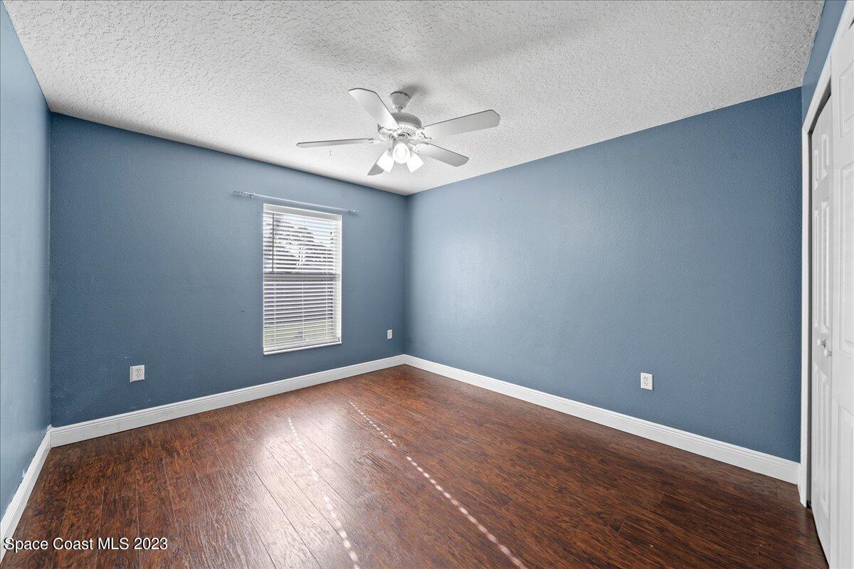 6949 Boston Road Cocoa, FL 32927 - Photo 16 of 33 wooden floor in an empty room with a window