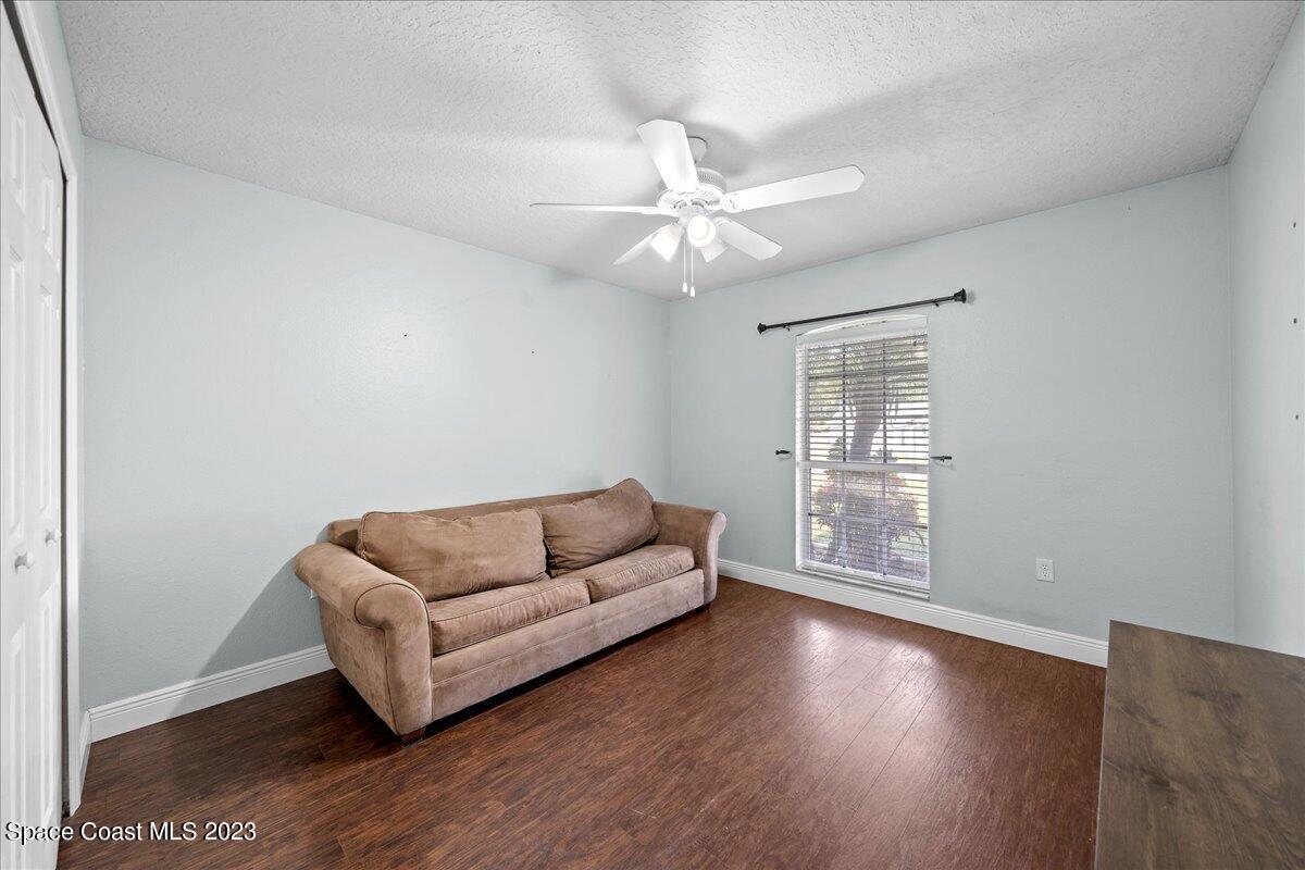 6949 Boston Road Cocoa, FL 32927 - Photo 17 of 33 a living room with furniture and a wooden floor