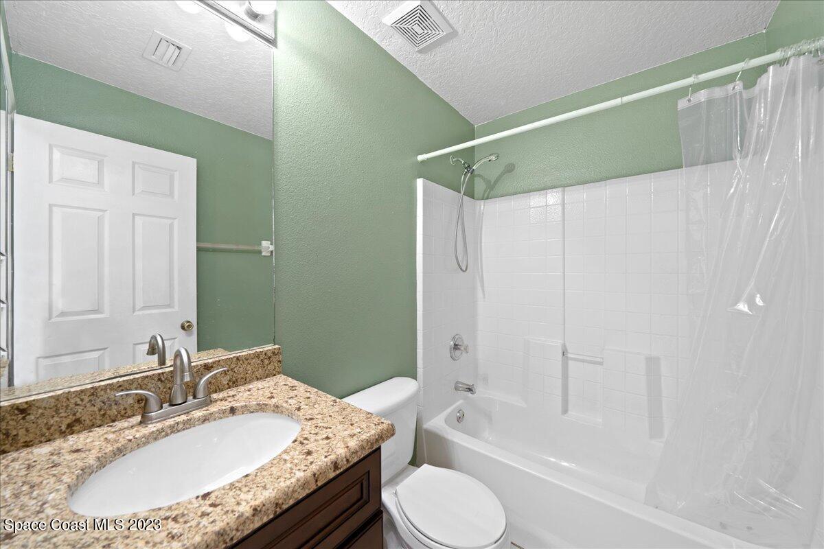 6949 Boston Road Cocoa, FL 32927 - Photo 18 of 33 a bathroom with a granite countertop sink toilet and shower