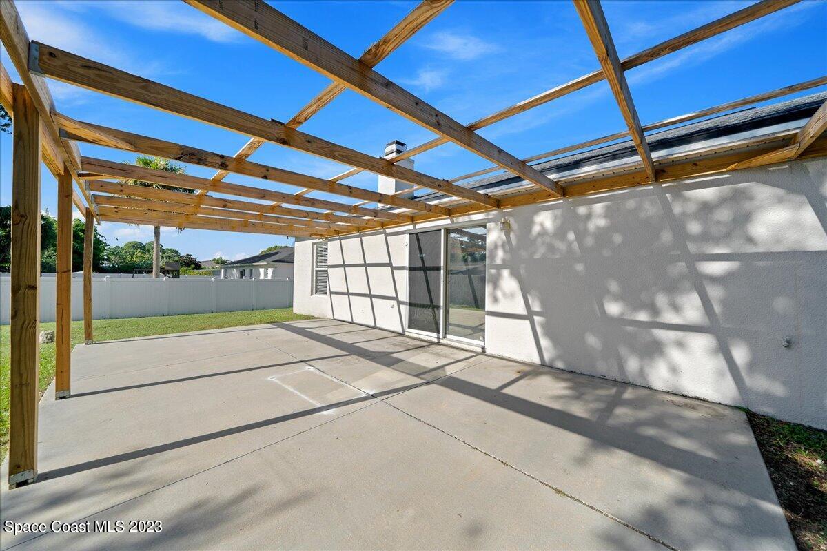6949 Boston Road Cocoa, FL 32927 - Photo 19 of 33 a view of an empty room with a sliding door