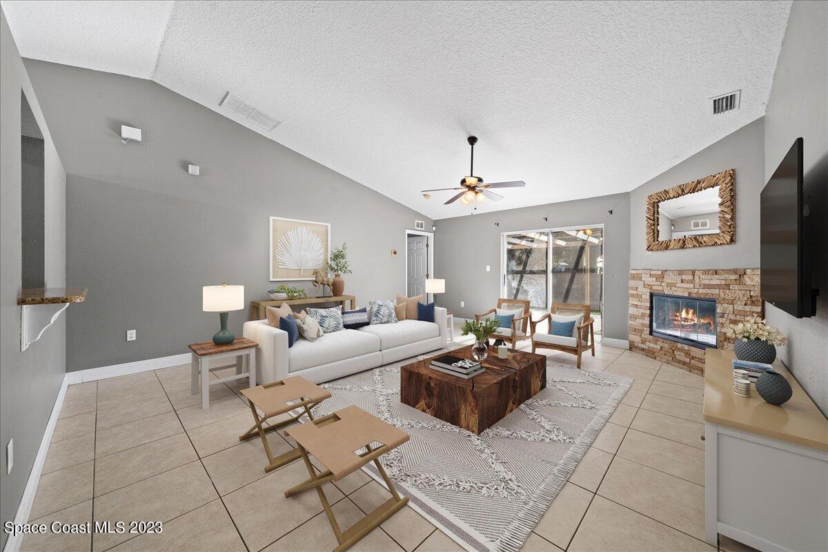 6949 Boston Road Cocoa, FL 32927 - Photo 9 of 33 a living room with fireplace furniture and a flat screen tv