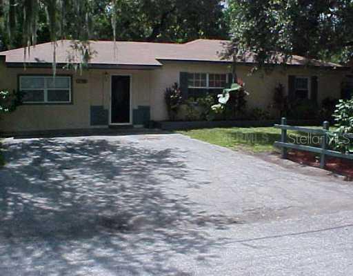 10816 North Teegreen Road Tampa, FL 33612 - Photo 1 of 1 a front view of a house with garden