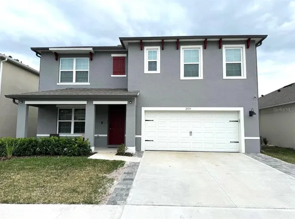 a view of a house with a yard and garage